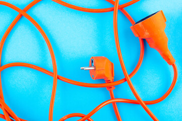 Orange electrical wire on blue background.