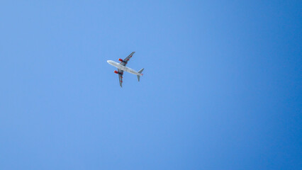Fototapeta na wymiar Airplane in the sky shot from below