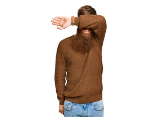 Young irish redhead man wearing casual clothes and glasses covering eyes with arm smiling cheerful...