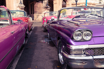 Vintage classic american car in Havana, Cuba. Typical Havana urban scene with colorful buildings and old cars.