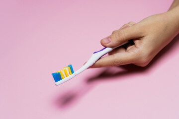 A close up of a person holding a toothbrush. High quality photo