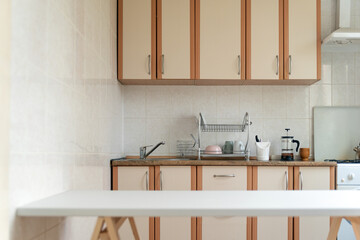 Kitchen interior in light pastel colors. White table. Modern kitchen design