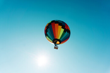 Flying in a multi-colored hot air balloon. Bottom up view. Copy space