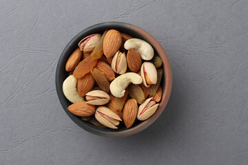 Assorted nuts in a clay bowl. 