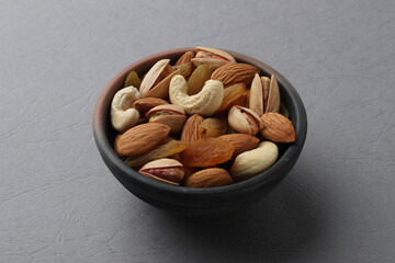 Assorted nuts in a clay bowl. 