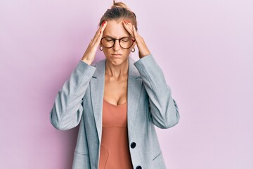 Beautiful caucasian woman wearing business jacket and glasses with hand on head for pain in head because stress. suffering migraine.