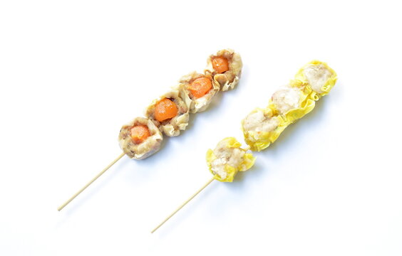 Chinese dumpling stuffed mashed pork with salty egg and crab stabbing wooden stick on white background