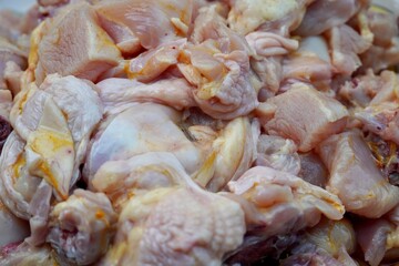 Raw chicken meat kept in a plate for sale in the market. Chicken meat chopped and kept in a plate for cooking in kitchen.
