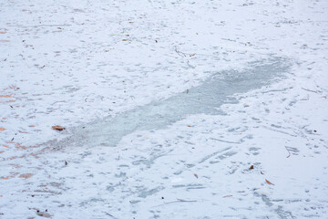 Textured winter surface of frozen water with ice and white snow
