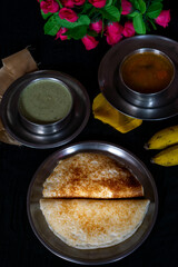 Homemade delicious set dosa in a plate on a dark background