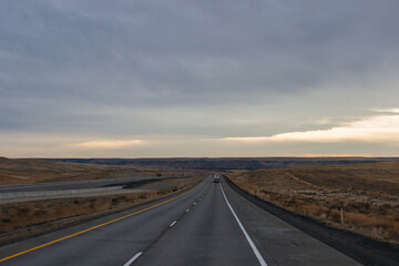 Highway in the middle of the mountains in a snowy winter. A beautiful asphalt road among the snow-covered mountains. Utah, USA
