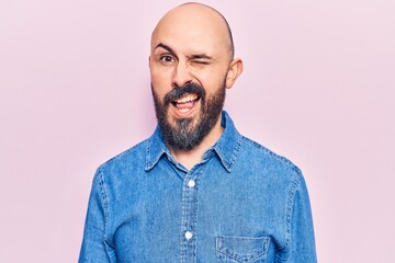 Fototapeta premium Young handsome man wearing casual clothes winking looking at the camera with sexy expression, cheerful and happy face.