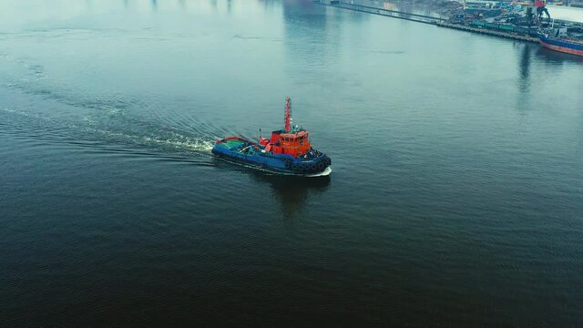 The tug returns to the port along the river. bird's-eye. aerial photography from a quadcopter.