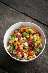 organic salsa salad on rustic old wood backgrond