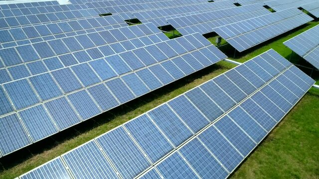 Aerial view of Solar Panels Farm (solar cell) with sunlight. Production of clean energy. Renewable green alternative energy concept.