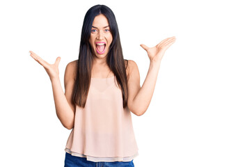 Young beautiful caucasian woman wearing casual clothes celebrating victory with happy smile and winner expression with raised hands