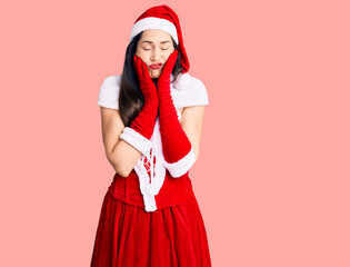 Young beautiful caucasian woman wearing santa claus costume tired hands covering face, depression and sadness, upset and irritated for problem