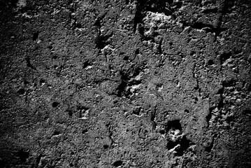 Abstract grungy wall background in a low key. Wall background in black and white.