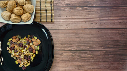 Mixed nuts, heart healthy food on a wooden background. Top view with copy space.