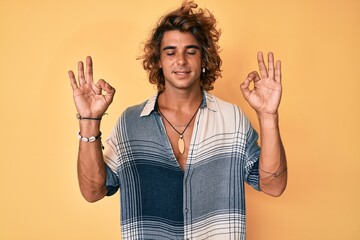 Young hispanic man wearing summer style relax and smiling with eyes closed doing meditation gesture with fingers. yoga concept.