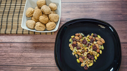 Mixed nuts, heart healthy food on a wooden background. Top view with copy space.