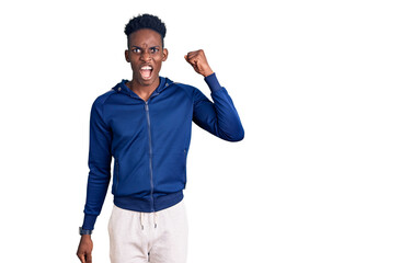 Naklejka premium Young african american man wearing sportswear angry and mad raising fist frustrated and furious while shouting with anger. rage and aggressive concept.