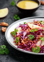 Red Cabbage salad with carrots, apples and pecan nuts. Healthy vegan food