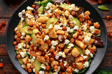 Roasted Cauliflower salad with chickpea, cucumber, greens and feta cheese. healthy food