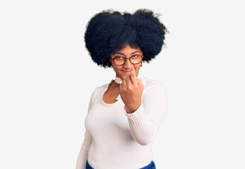 Young african american girl wearing casual clothes and glasses beckoning come here gesture with hand inviting welcoming happy and smiling