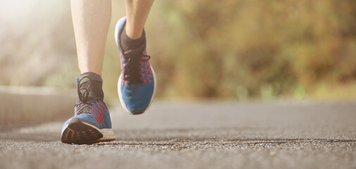 Fitness man runner athlete running at road, working out cardio on nature landscape