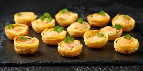 Mini party Fish Pie Food with prawn on rustic stone background