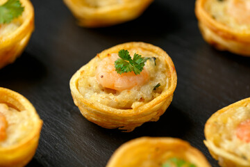 Mini party Fish Pie Food with prawn on rustic stone background