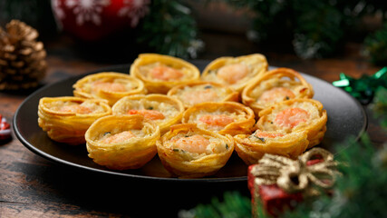 Obraz na płótnie Canvas Mini party Fish Pie Food with decoration, gifts, green tree branch on wooden rustic table