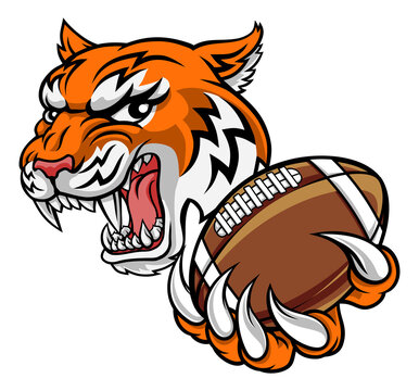 A tiger American Football player cartoon animal sports mascot holding a ball in its claw
