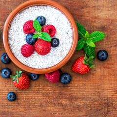 Chia seed pudding made with fruits and fresh  berries over wood background. Chia seeds Yogurt.