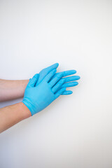 Hands in blue medical disposable gloves show a hand washing pattern