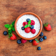 Chia seed pudding made with fruits and fresh  berries over wood background. Chia seeds Yogurt.