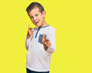 Adorable caucasian kid wearing casual clothes pointing fingers to camera with happy and funny face. good energy and vibes.