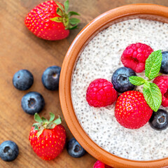 Chia seed pudding made with fruits and fresh  berries over wood background. Chia seeds Yogurt.