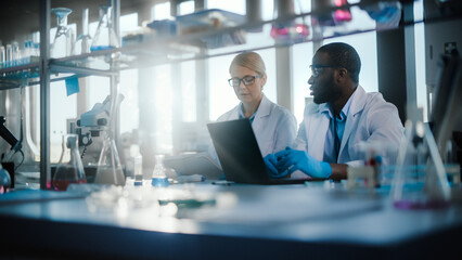 Bright Medical Science Laboratory with Diverse Team of Research Scientists Working. Young Female...