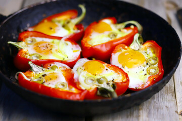 Selective focus. Macro. Baked red peppers with egg in a frying pan. Healthy food. The keto diet.