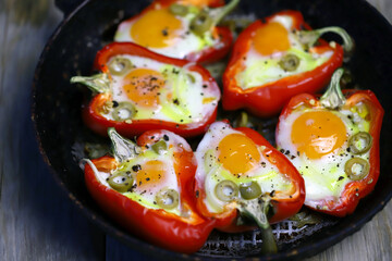 Selective focus. Macro. Baked red peppers with egg in a frying pan. Healthy food. The keto diet.