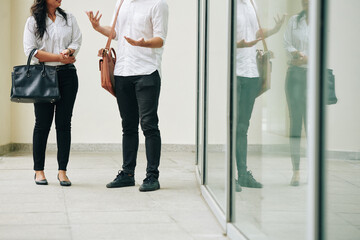 Fototapeta premium Cropped image of young business people standing outside office building and talking about important issues