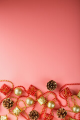 Christmas or new Year pink background with red and gold decorations for Christmas tree with free space.