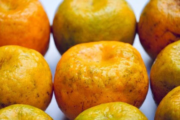 Sweet orange fruit kept in the market stall for sale. Orange fruit isolated in white background. Sweet orange and its shadow.