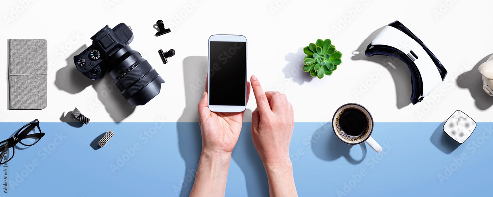 Poster person using a smartphone with a vr and a slr camera