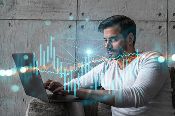 A serious caucasian analyst in casual wears, using laptop to proceed the forecast of stock market...