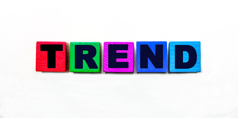 The word TREND is written on colorful cubes on a light background