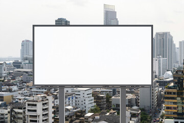 Obraz premium Blank white road billboard with Bangkok cityscape background at day time. Street advertising poster, mock up, 3D rendering. Front view. The concept of marketing communication to promote or sell idea.