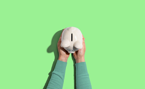 Person Holding A Piggy Bank From Above